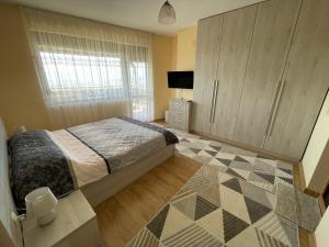 a bedroom with a bed and a television in it at Panorama view apartment in Sandanski