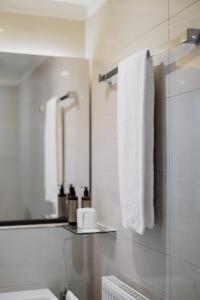 een badkamer met een witte handdoek aan de muur bij The Pure, Frankfurt, a Member of Design Hotels in Frankfurt am Main