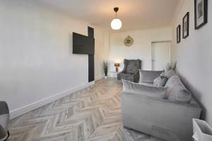 a living room with a couch and two chairs at Host & Stay - Spring Cottage in West Rainton