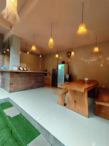 a room with a table and a counter with lights at Pondok Kita in Canggu