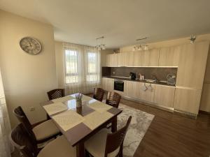 a kitchen and dining room with a table and chairs at Panorama view apartment in Sandanski