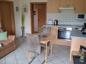 a kitchen with a table and a couch in a room at Ferienwohnung Fischer in Heringhausen