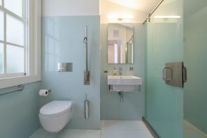 a bathroom with a toilet and a sink and a shower at Porto Lounge Hostel & Guesthouse in Porto