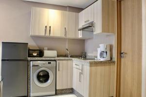 a kitchen with a washing machine and a washer at Atlas-Résidence by Rent-Inn in Rabat