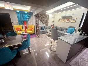 a living room with a couch and a table and chairs at luxury flat with garden and private entrance شقة فاخرة بحديقة و مدخل خاص in Cairo