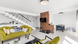 a living room with a yellow couch and a staircase at Villa Chic by Villas Holiday in Umag