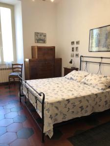 a bedroom with a bed and a dresser in it at Casa in Trastevere in Rome