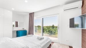 a bedroom with a bed and a large window at Villa Chic by Villas Holiday in Umag +32 photos