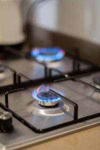 a gas stove top with a blue burner on it at Metropolitan 06-Two Bedrooms - Cavalli Luxury Flat in Casablanca