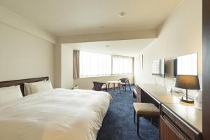 Postel nebo postele na pokoji v ubytování Awa Kanko Hotel