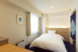Postel nebo postele na pokoji v ubytování Awa Kanko Hotel