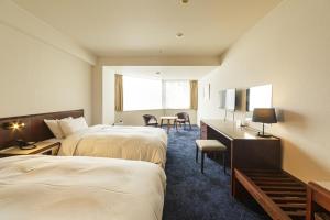 Postel nebo postele na pokoji v ubytování Awa Kanko Hotel