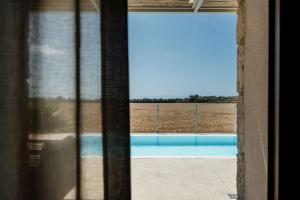 a window view of a field from a house at Villa Verde in Ragusa