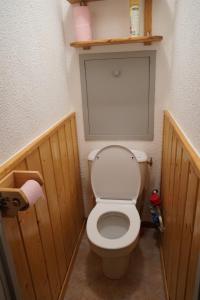 a bathroom with a toilet in a wooden room at ski-in ski-out 108 in Val Thorens