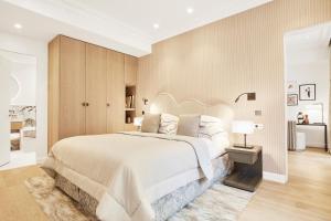a bedroom with a large white bed and a table at Grand Hôtel Du Palais Royal in Paris +90 photos