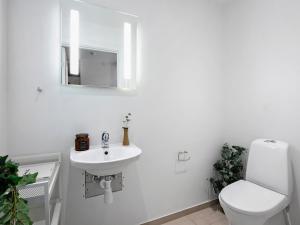 een witte badkamer met een toilet en een wastafel bij Sanders Leaves - Charming Three-Bedroom Apartment In Downtown Copenhagen in Kopenhagen