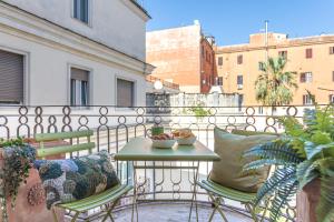 a balcony with a table and chairs on a balcony at Oasis Rome Centre Apartment in Rome