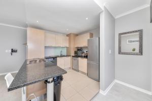 a kitchen with stainless steel appliances and a counter top at Horizon Bay 702 in Bloubergstrand