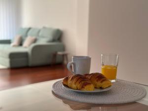 a plate of croissants and a glass of orange juice at Tropical Garden in Caniço