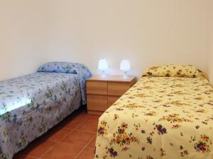 Tempat tidur dalam kamar di La Giara - holiday apartments