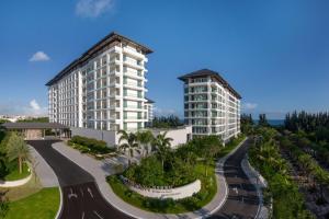 un rendimiento de un edificio junto a una carretera en The Mermoon Resort Hainan Tufu Bay, Tapestry By Hilton, en Lingshui