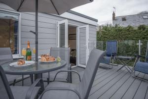 a patio with a table and chairs and an umbrella at Sea Breeze Apt 2 - 2 Bedroom - Horton Beach in Horton