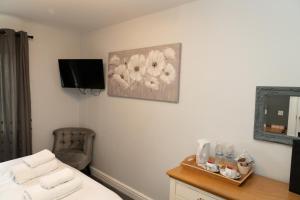 een slaapkamer met een bed en een bureau met een spiegel bij The Finch Hatton Arms in Sleaford