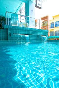 a swimming pool with blue water in a building at Kata Sea Host in Kata Beach