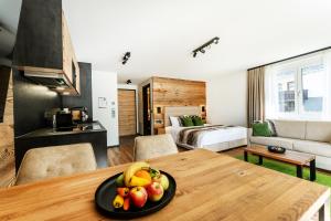 a room with a table with a bowl of fruit on it at Black Forest Luxury Apartment Bärenhöhle mit Sauna in Schluchsee