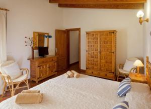 Un dormitorio con una cama, una cómoda y un televisor. en Ca Na Rita den Constantino - Formentera Break, en Playa de Migjorn 22 fotos más