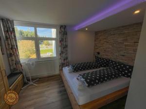 a bedroom with two beds and a window at Pleskini Apartment in Sankt Englmar