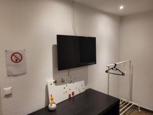 um quarto com uma televisão de ecrã plano na parede em Gästezimmer em Springe