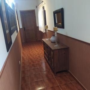 a hallway with a tiled floor and a mirror at El ZAMACÉN in Burbáguena