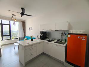 a kitchen with white cabinets and a red refrigerator at Kanvas Soho Cyberjaya/Netflix/Gym/Jacuzzi/KLIA in Cyberjaya +78 photos