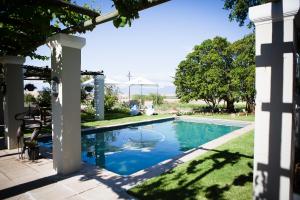 a swimming pool in the yard of a house at Doran Vineyards in Paarl