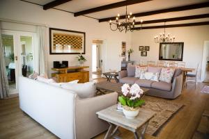 a living room with a couch and a table at Doran Vineyards in Paarl