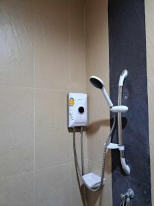 uma cabeça de chuveiro e um telefone na casa de banho em TG Apartment Aonang em Praia de Ao Nang