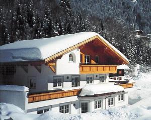 a large building with snow on top of it at Ferienwohnung Carbonare in Sankt Gallenkirch +5 photos