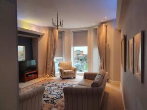 a living room with two couches and a television at Roker North cliff Sea View in Sunderland