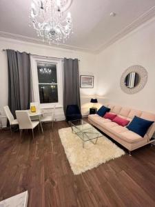 a living room with a couch and a table at Iconic One Bed Apartment in Chiswick in London