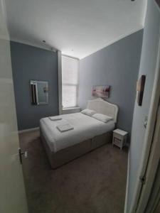 a small bedroom with a bed and a window at Northcliffe Sea View in Sunderland