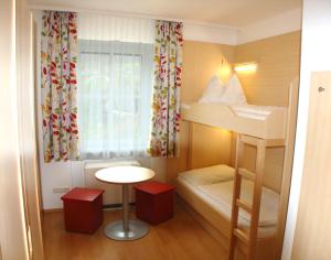 A bed or beds in a room at Jugendgästehaus St. Gilgen