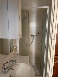 a bathroom with a shower and a white sink at Casa Carla … per le tue vacanze in Ventimiglia
