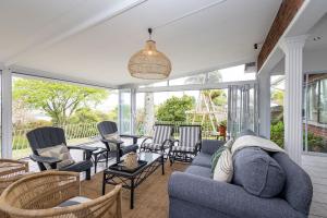 a living room with a blue couch and chairs at Bergview Apartments in Hilton