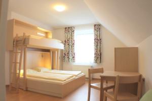 A bed or beds in a room at Jugendgästehaus St. Gilgen