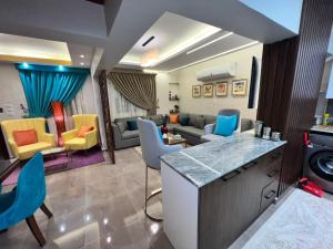 a living room with colorful chairs and a couch at luxury flat with garden and private entrance شقة فاخرة بحديقة و مدخل خاص in Cairo