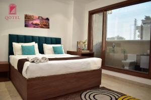 a bedroom with a large bed and a bathroom at Qotel Hotel Ashok Vihar Couple Friendly in New Delhi