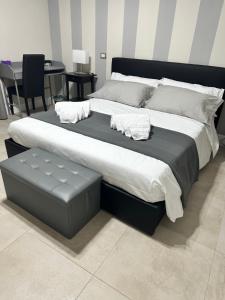 a large bed in a room with a table at La Finestra Sul Vulcano in Roccamonfina