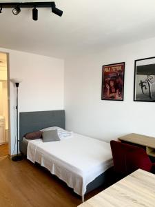 a bedroom with a bed and a picture on the wall at Apartament Oliwa in Gdańsk