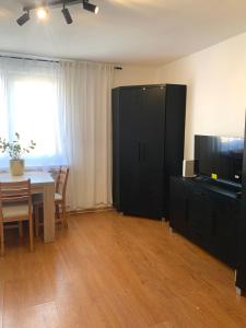 a living room with a table and a black cabinet at Apartament Oliwa in Gdańsk